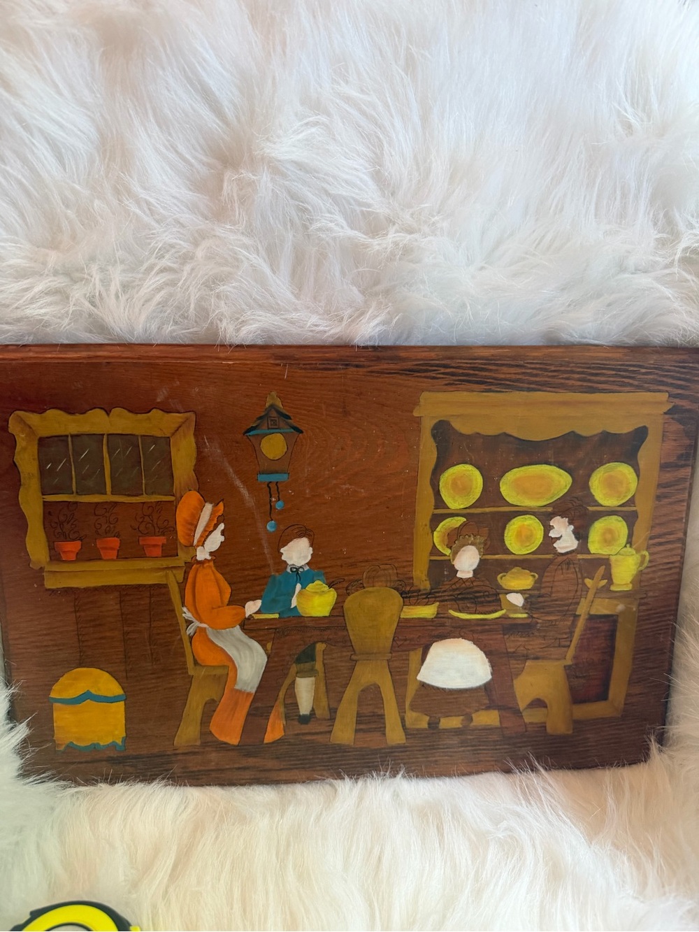 A mid-century American folk art painted wooden panel with a domestic scene.